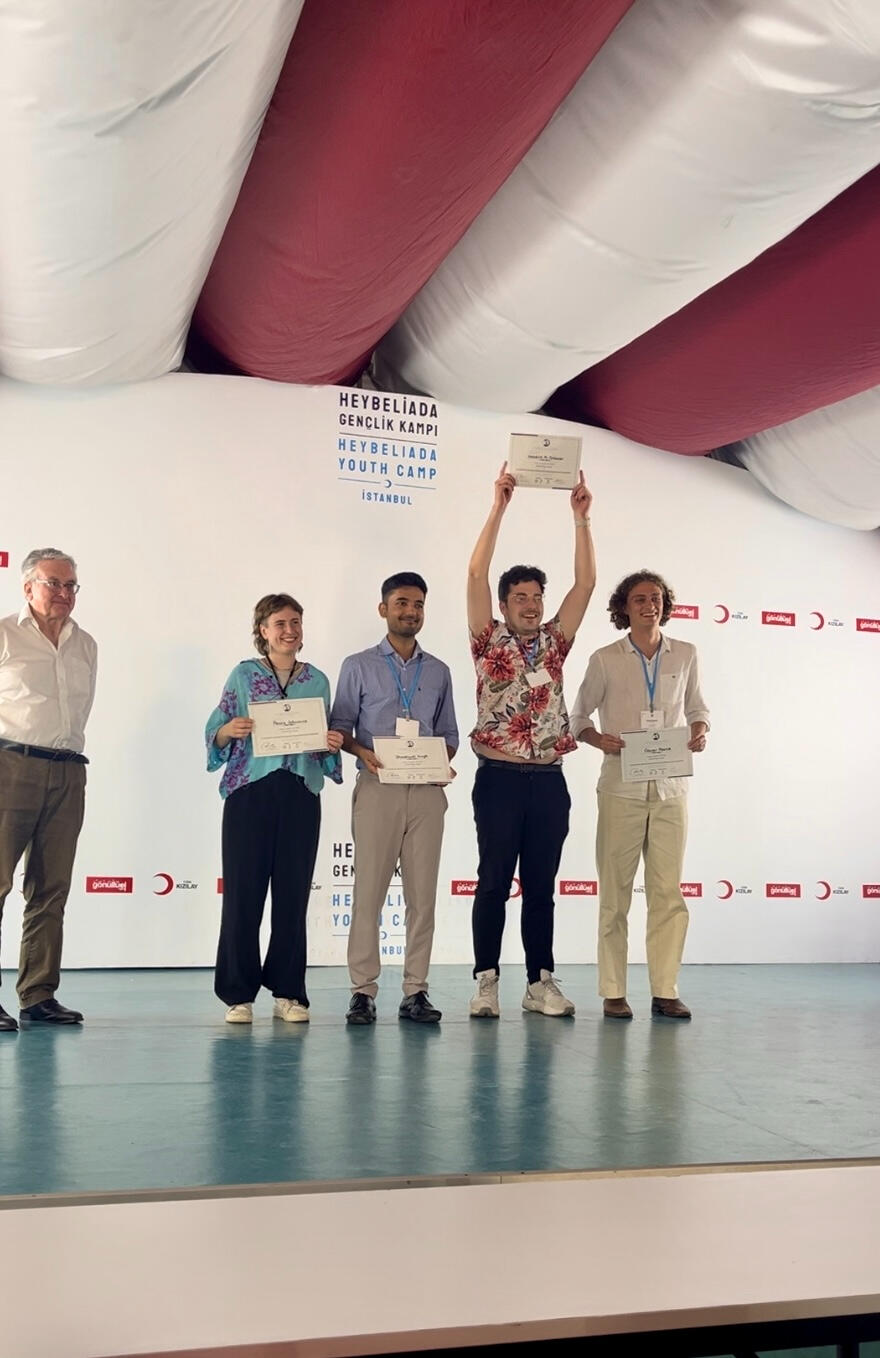 The announcement of the Winners, left to right: Sir Michael Wood KC, Paula, Sashwat, Hendrik, Oscar.